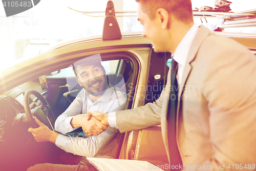 Image of happy man with car dealer in auto show or salon