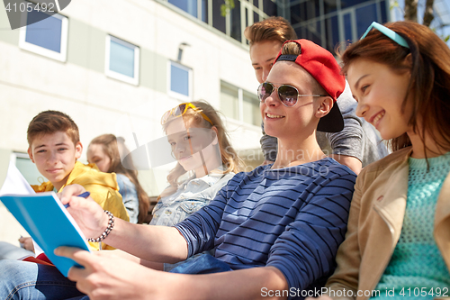 Image of group of students with notebooks at school yard