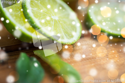 Image of lime slices on wooden table
