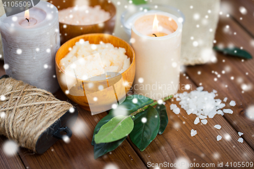 Image of natural body scrub and candles on wood