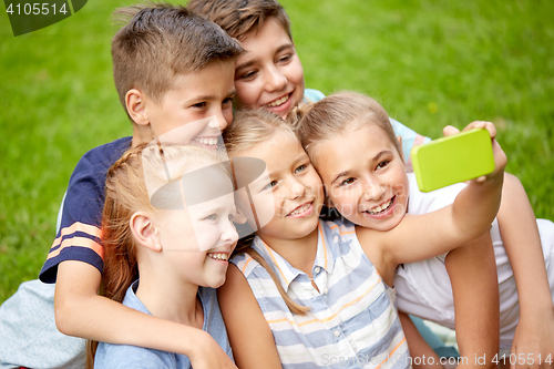 Image of happy kids or friends taking selfie in summer park