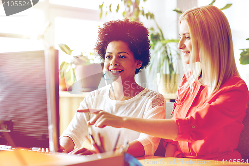 Image of happy women or students with computer in office