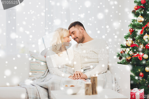 Image of happy couple at home with christmas tree