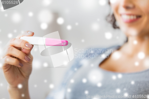 Image of close up of happy woman with home pregnancy test