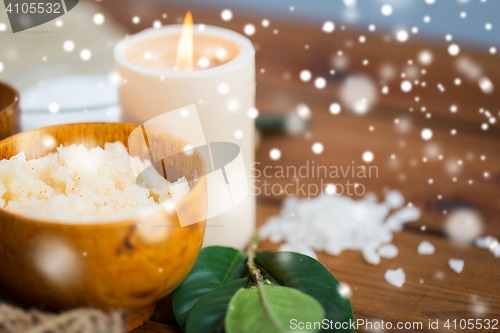 Image of natural body scrub and candle on wood