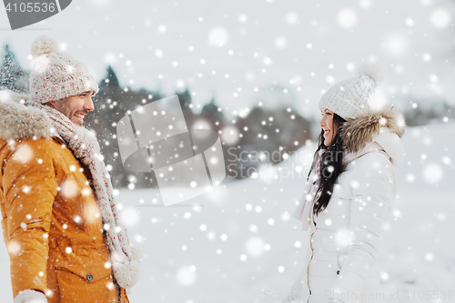 Image of happy couple walking over winter background