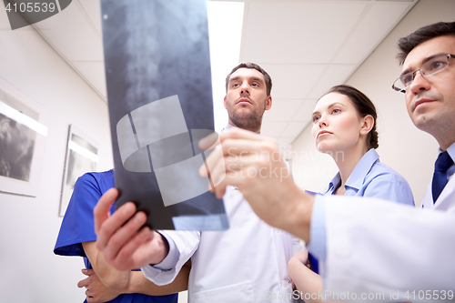 Image of group of medics with spine x-ray scan at hospital