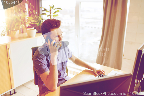 Image of happy creative male worker calling on smarphone