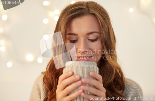 Image of happy woman with cup of tea or coffee at home