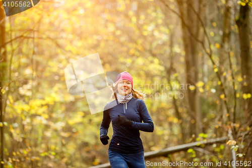Image of Smiling sportswoman runs in morning