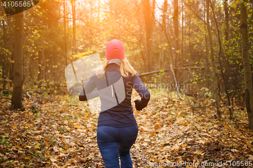 Image of Young girl running in park