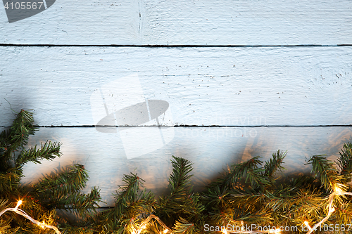 Image of Wooden white texture background with christmas fir tree and lightbulb