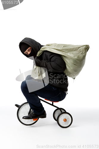 Image of Thief in mask on bicycle