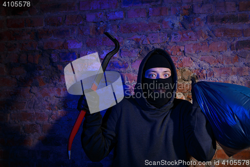 Image of Night gangster near brick wall