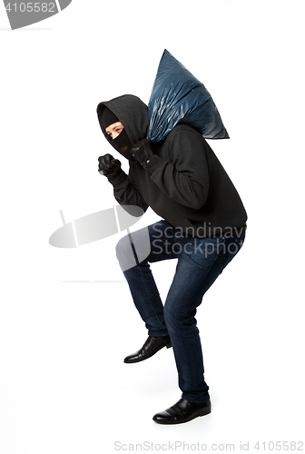 Image of Burglar slinking with large bag