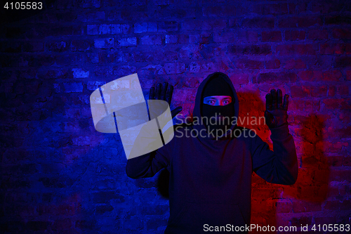 Image of Trapped burglar standing near wall