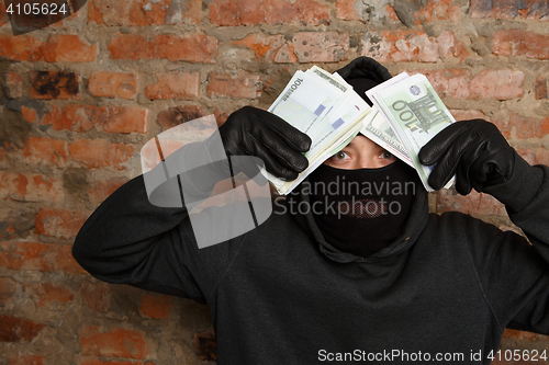 Image of Burglar standing in black mask