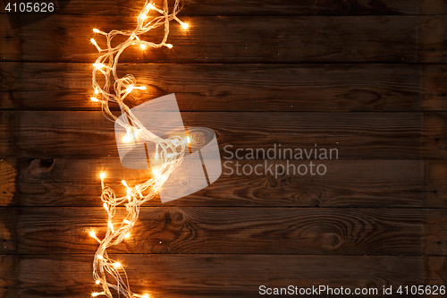 Image of Glowing garland on wooden floor