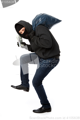 Image of Burglar steals money and bag
