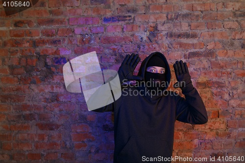 Image of Burglar in wall at night