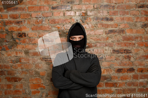 Image of Serious thief with crossed arms