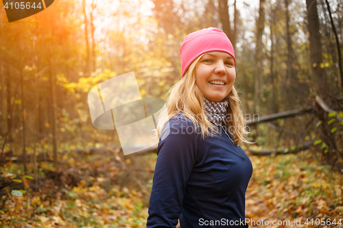 Image of Young woman running in park