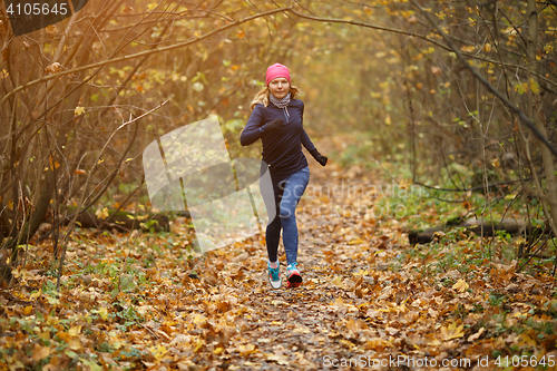 Image of Sportswoman going sports in park