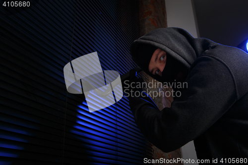 Image of Robber with picklock at night