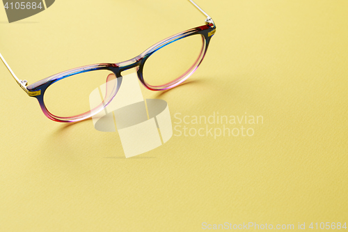 Image of Blue-pink glasses on yellow space
