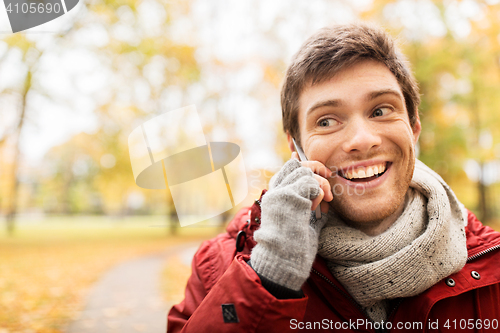 Image of man with smartphone calling on city street