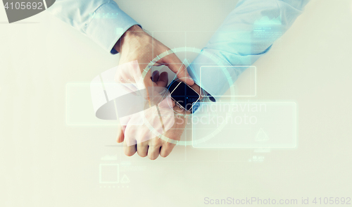 Image of hand with smartwatch and virtual screen projection