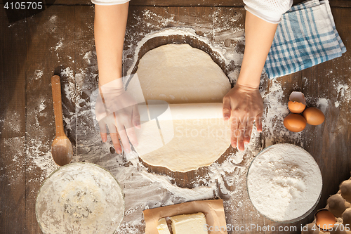 Image of Female cooking dough.