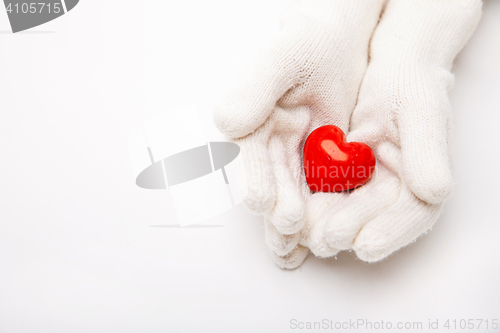 Image of Woman hands in white gloves holding heart symbol