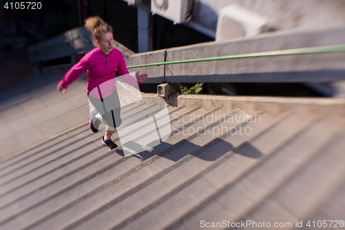 Image of woman jogging on  steps