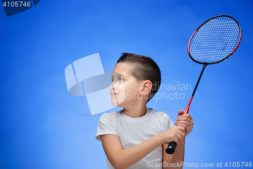 Image of The boy with badminton rackets outdoors