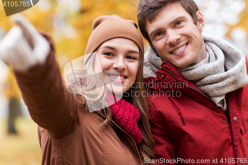 Image of close up of happy couple walking in autumn park