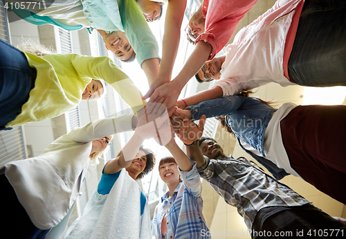 Image of group of international students with hands on top