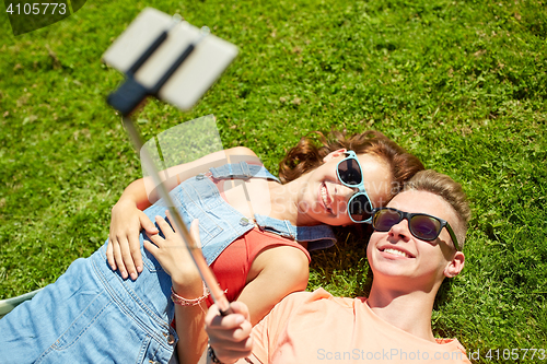 Image of happy couple taking selfie on smartphone at summer