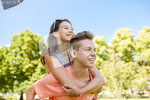 Image of happy teenage couple having fun at summer park