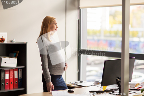 Image of pregnant businesswoman with computer at office