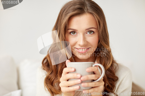 Image of close up of happy woman with coffee cup at home