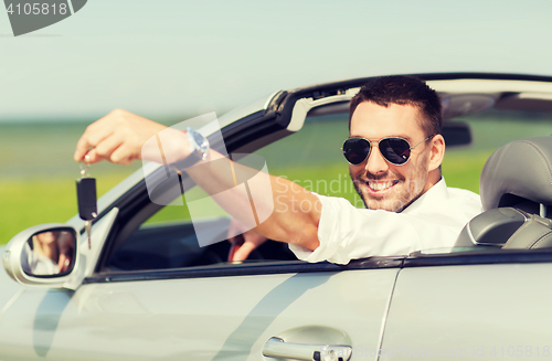 Image of happy man in cabriolet showing car key