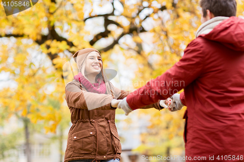 Image of happy young couple having fun in autumn park