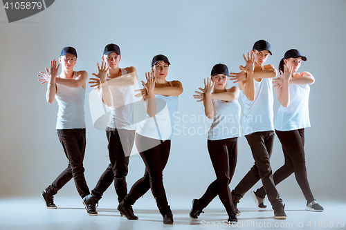 Image of Group of men and women dancing hip hop choreography