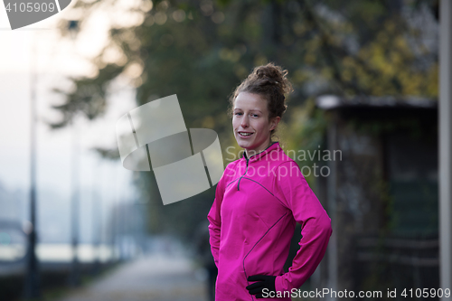 Image of woman  stretching before morning jogging