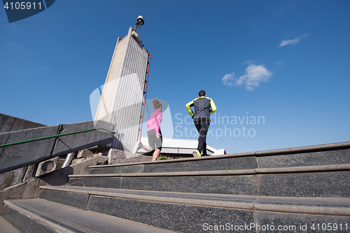 Image of young  couple jogging on steps