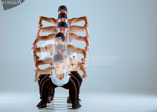 Image of Group of men and women dancing hip hop choreography