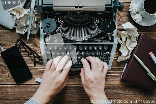 Image of Writer typing with retro writing machine.