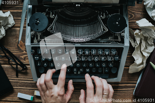 Image of Writer typing with retro writing machine.