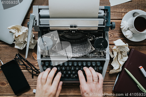 Image of Writer typing with retro writing machine.